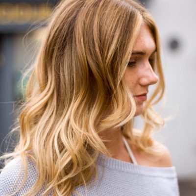 Side view of ladies blonde balayage with natural wave by Stu Weller Hair